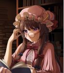  1girl adjusting_eyewear bespectacled book bookshelf bow commentary_request crescent crescent_hat_ornament emoriza glasses hair_bow hat hat_ornament highres mob_cap patchouli_knowledge purple_hair reading sidelocks signature solo touhou violet_eyes 