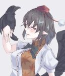  1girl bird bird_on_hand bird_wings black_bow black_bowtie black_hair black_wings bow bowtie brown_eyes commentary_request crow grey_background hat highres kanaria_(bocmn) looking_at_viewer open_mouth pointy_ears pom_pom_(clothes) red_headwear shameimaru_aya short_hair short_sleeves simple_background tokin_hat touhou upper_body wings 