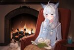  1girl bird blanket book book_on_lap breasts collarbone fireplace heterochromia highres holding holding_book hot_drink indie_virtual_youtuber light_smile long_sleeves mikazuki_silvi nakonbu owl owl_ears owl_girl pajamas small_breasts solo_focus virtual_youtuber white_hair 