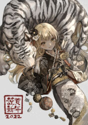  1girl 2022 animal arrow_(projectile) ball black_gloves black_kimono blonde_hair chinese_zodiac closed_mouth commentary_request ema feet_out_of_frame floral_print flower gloves hair_flower hair_ornament hamaya happy_new_year highres holding holding_arrow japanese_clothes kimono long_hair long_sleeves looking_at_viewer lying marutani new_year obi on_back original print_kimono sash smile solo tassel tiger white_flower white_tiger wide_sleeves year_of_the_tiger yellow_eyes 