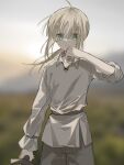  1girl ahoge artoria_pendragon_(fate) belt blonde_hair blurry blurry_background collarbone fate/stay_night fate_(series) green_eyes grey_pants hand_up highres looking_at_viewer medium_hair nayu_tundora pants ponytail shirt sidelocks sleeves_rolled_up solo sweat sword tunic weapon white_shirt white_tunic wiping_sweat wooden_sword 
