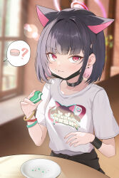  1girl ? absurdres animal_ears black_collar black_hair blue_archive blurry blurry_background cat_ears closed_mouth collar commentary crumbs depth_of_field earclip earrings eating food food_bite food_on_face hair_ornament halo hand_up highres holding holding_food indoors jewelry kazusa_(band)_(blue_archive) kazusa_(blue_archive) l_cy long_sleeves looking_at_viewer mask mask_pull mouth_mask pink_eyes pink_halo plate print_shirt shirt short_hair solo speech_bubble spoken_food spoken_question_mark stud_earrings t-shirt table upper_body white_shirt wristband 