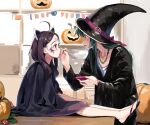  2girls ahoge black_footwear black_headwear black_robe brown_hair brown_skirt closed_mouth collarbone commentary_request facepaint green_eyes green_hair hair_ornament hairclip halloween hat headgear highres holding jack-o&#039;-lantern lamb_(hitsujiniku) long_hair long_sleeves multiple_girls on_table parted_bangs profile robe shirt sitting skirt string_of_flags table touhoku_kiritan touhoku_zunko voiceroid white_shirt wide_sleeves witch_hat zouri 