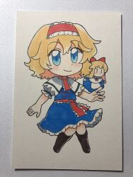  1girl alice_margatroid bad_id bad_twitter_id blonde_hair blue_dress blue_eyes boots brown_boots capelet chibi chibi_only closed_mouth commentary doll dress frilled_hairband frilled_sash frills full_body hairband highres jewelry knee_boots lace-up_boots lolita_hairband looking_at_viewer maa_(forsythia1729) medium_hair photo_(medium) puffy_short_sleeves puffy_sleeves puppet_rings red_hairband ring sash shanghai_doll short_sleeves smile solo touhou traditional_media white_capelet 