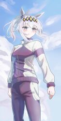  1girl absurdres ahoge animal_ears blue_eyes blue_sky blush breasts closed_mouth clouds commentary_request ear_ornament grey_hair hair_between_eyes hairband highres horse_ears horse_girl jacket kasamatsu_tracen_training_uniform long_hair long_sleeves memai_(memai1129) multicolored_hair multicolored_jacket oguri_cap_(umamusume) outdoors pants ponytail purple_jacket purple_pants purple_track_suit sky smile solo track_jacket track_pants track_suit two-tone_jacket umamusume umamusume:_cinderella_gray 