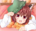  1girl :d absurdres animal_ear_piercing animal_ears blush bow bowtie brown_eyes brown_hair cat_ears chen chinoru close-up commentary_request earrings fang food fruit hair_between_eyes hand_up hat highres jewelry kotatsu long_sleeves looking_at_viewer lying mob_cap on_stomach open_mouth orange_(fruit) red_vest short_hair single_earring skin_fang smile solo table touhou under_kotatsu under_table vest yellow_bow yellow_bowtie 