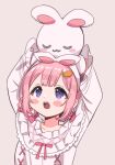  1girl :o animal_ears arms_up blush braided_hair_rings carrot_hair_ornament fake_animal_ears food-themed_hair_ornament grey_background hair_ornament hairband highres holding holding_stuffed_toy long_sleeves looking_up nightgown nijisanji object_on_head official_alternate_costume open_mouth pink_hair pink_nightgown pink_ribbon rabbit_ears ribbon saito_katuo simple_background solo stuffed_animal stuffed_rabbit stuffed_toy suo_sango suo_sango_(2nd_costume) upper_body violet_eyes virtual_youtuber white_hairband 