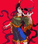  1girl absurdres black_hair blue_shorts breasts collarbone feet_out_of_frame fingernails green_shirt grin highres horns long_fingernails long_hair luhua_xiedai nail_polish nippaku_zanmu oni_horns red_background red_eyes red_nails sharp_fingernails shirt short_sleeves shorts simple_background skull small_breasts smile solo touhou wide_sleeves yellow_horns 