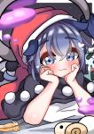  1girl :3 absurdres black_capelet blue_eyes blue_hair blush capelet closed_mouth commentary_request doremy_sweet eyes_visible_through_hair feathers hands_on_own_cheeks hands_on_own_face hat heart highres kkfri_2525 lying on_bed on_stomach red_headwear shirt short_hair solo touhou white_shirt 