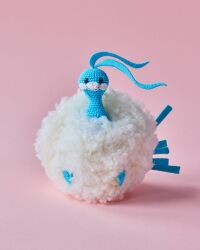  altaria amigurumi_(medium) animal_focus asako_ito closed_mouth fluffy full_body highres no_humans official_art photo_(medium) pink_background pokemon pokemon_(creature) pokemon_focus pokemon_tcg second-party_source shadow simple_background smile solo unconventional_media 