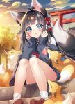  1girl animal_ears black_hair blue_eyes blush charm_(object) clouds fox fox_ears fox_tail highres hisana looking_at_viewer open_mouth original school_uniform shrine sitting sky solo stairs tail torii 