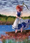  1girl blue_dress blurry blurry_foreground closed_mouth clouds cloudy_sky coin commentary_request dress flower full_body hair_bobbles hair_ornament highres holding holding_scythe kyabekko light_particles obi onozuka_komachi outdoors red_eyes redhead river sash scythe short_sleeves sky solo spider_lily touhou tree two_side_up 