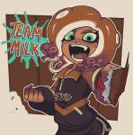  1girl brown_hair candy chocolate chocolate_bar clenched_hand commentary dark-skinned_female dark_skin dolphin_shorts english_commentary fangs food foreshortening freckles green_eyes highres holding holding_chocolate holding_food octoling octoling_girl open_mouth saurit shorts smile solo splatoon_(series) splatoon_3 tentacle_hair 