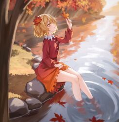  1girl aki_shizuha autumn_leaves blonde_hair chinese_commentary chunjiu collared_shirt commentary_request day falling_leaves hair_ornament highres holding holding_leaf leaf leaf_hair_ornament long_sleeves maple_leaf outdoors red_shirt red_skirt ripples river shirt short_hair sitting skirt smile soaking_feet solo thighs touhou tree water yellow_eyes 