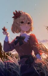  1girl aki_shizuha black_bow black_bowtie blonde_hair bow bowtie breasts closed_mouth commentary_request dated dress hair_between_eyes hair_ornament highres holding holding_leaf leaf leaf_hair_ornament long_sleeves maple_leaf orange_dress outdoors short_hair small_breasts solo tami_(joemanyodw) touhou wheat 