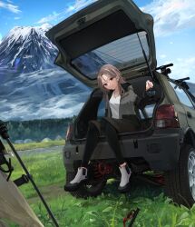  1girl absurdres black_leggings blue_sky boots brown_hair brown_shorts camping car car_trunk commentary_request day grass green_car grey_jacket highres holding holding_lantern honda honda_today in_trunk jacket jewelry lantern leggings long_hair looking_at_viewer masa_(siriusu-koko) motor_vehicle mountain necklace original outdoors shirt shorts sitting sky smile solo tent violet_eyes white_boots white_shirt 