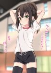 1girl arms_behind_head arms_up black_hair black_shorts black_thighhighs blurry blurry_background blush closed_mouth collarbone commentary_request depth_of_field dolphin_shorts green_eyes gym_shirt hair_between_eyes hair_ornament hairclip highres indoors long_hair looking_at_viewer original ponytail shirt short_shorts short_sleeves shorts sidelocks solo sweat takasuma_hiro thigh-highs translation_request white_shirt 