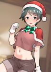  1girl alternate_costume aqua_eyes blurry blurry_background breasts brown_shirt brown_shorts capelet fur-trimmed_capelet fur-trimmed_headwear fur_trim furaggu_(frag_0416) gloves green_hair hat highres indoors kantai_collection midriff mogami_(kancolle) navel red_capelet red_headwear santa_hat shirt short_hair short_shorts short_sleeves shorts small_breasts solo white_gloves 
