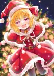  1girl artist_name black_thighhighs blonde_hair blurry capelet christmas christmas_tree depth_of_field dress hat looking_at_viewer night night_sky red_capelet red_dress red_headwear rumia sakuyabm santa_costume santa_hat sky smile solo thigh-highs touhou 