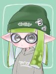  1girl beanie blush closed_mouth commentary_request green_background green_headwear grey_eyes grey_hoodie hat highres hood hoodie inkling inkling_girl long_hair mina_p pointy_ears print_headwear simple_background solo splatoon_(series) tentacle_hair upper_body 