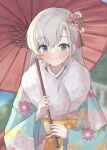  1girl absurdres blue_eyes blurry blurry_background blush braid braided_bangs floral_print fur-trimmed_kimono fur_trim grey_hair hair_ornament highres hisakawa_hayate holding holding_umbrella idolmaster idolmaster_cinderella_girls japanese_clothes kimono looking_at_viewer oil-paper_umbrella sangria smile solo tassel tassel_hair_ornament umbrella upper_body yukata 