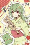  1girl 2024 blush calligraphy_brush chinese_zodiac dragon green_hair hagoita hane_(hanetsuki) heterochromia highres holding holding_paddle ink_on_face japanese_clothes kimono long_hair long_sleeves looking_at_viewer new_year obi original outline paddle paintbrush rageno0000 red_eyes sash smile solo thick_eyebrows translation_request very_long_hair wide_sleeves year_of_the_dragon yellow_eyes 