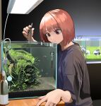  1girl aquarium black_nails brown_eyes fish fish_tank grey_shirt guppy_(fish) highres holding_table holding_tweezers lamp looking_down mmmo3 nail_polish original redhead shirt solo t-shirt table thermometer tweezers water_filter 