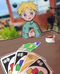 1boy bicycle blonde_hair blue_eyes blue_shirt blurry blurry_background blush_stickers butters_stotch card child comedy depth_of_field highres holding holding_card looking_at_viewer omochisan216 open_mouth outdoors outline playing_card pov shirt smile solo south_park table turtleneck uno_(game) white_outline