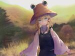  1girl :3 absurdres aqua_eyes blonde_hair blush brown_headwear closed_mouth colored_eyelashes commentary_request cowboy_shot day eyes_visible_through_hair hair_between_eyes hair_ribbon hat highres kiritanpo117 long_sleeves looking_at_viewer moriya_suwako onbashira outdoors purple_skirt purple_vest red_ribbon ribbon shirt short_hair_with_long_locks skirt smile solo touhou tress_ribbon twitter_username vest white_shirt wide_sleeves 