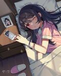  1girl bad_source bed black_hair blanket blush cellphone hair_between_eyes highres kawashima_yaruki long_hair lying one_eye_closed open_mouth original pajamas phone pink_pajamas red_eyes sandals smartphone solo waking_up yaruwashi 