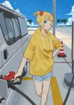  1girl beach black_footwear blonde_hair blue_eyes blue_sky closed_mouth clouds commentary_request denim denim_shorts double_bun foot_out_of_frame gas_pump gas_pump_nozzle gas_station hair_bun hand_on_own_hip highres holding hood hoodie looking_at_viewer mashiro_ka motor_vehicle one_eye_closed original palm_tree road short_hair shorts sky solo traffic_cone tree van yellow_hoodie yellow_nails 