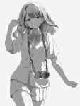  1girl absurdres bow bowtie camera camera_around_neck commentary_request cowboy_shot greyscale hand_in_own_hair hand_up highres long_hair looking_at_viewer miniskirt monochrome original pleated_skirt school_uniform shimkarom short_sleeves skirt solo sweater_vest 