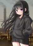  1girl akemi_homura black_hair black_hairband black_hoodie blurry closed_mouth commentary depth_of_field dot_mouth expressionless floating_hair hairband hands_in_pockets highres hood hood_down hoodie industrial_pipe long_hair mahou_shoujo_madoka_magica mahou_shoujo_madoka_magica_(anime) riuriumagi solo standing violet_eyes 