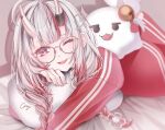  artist_name bed_sheet blurry blurry_background braid commentary_request cray glasses gradient_hair hair_between_eyes hololive looking_at_viewer low_twin_braids lying multicolored_hair nakiri_ayame nakiri_ayame_(off-work) on_stomach one_eye_closed open_mouth pillow poyoyo_(nakiri_ayame) red_eyes red_track_suit redhead streaked_hair twin_braids virtual_youtuber white_hair 