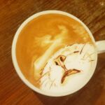  animal animal_focus cat close-up closed_eyes coffee cup drink george_(yamamoto_kazuki) latte_art latte_art_(medium) no_humans original photo_(medium) solo unconventional_media 