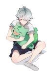  1boy alhaitham_(genshin_impact) black_shorts blush bulbasaur closed_eyes commentary_request crossover fangs flats genshin_impact grey_hair hair_between_eyes hair_over_one_eye holding holding_pokemon inuttm_sk male_focus multicolored_hair open_mouth pokemon pokemon_(creature) shirt shoes short_sleeves shorts simple_background sitting twitter_username white_background white_shirt 