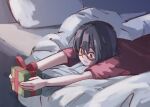  1girl black_hair box closed_mouth commentary egakuning english_commentary gift gift_box glasses highres holding holding_gift indoors kamikoshi_sorawo lying on_bed on_stomach pillow red_shirt shirt short_hair short_sleeves solo urasekai_picnic 