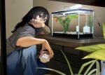  1girl black_hair blue_nails blue_pants blurry blurry_foreground cable covered_mouth covering_own_mouth fish fish_tank goldfish grey_shirt hand_up highres holding indoors lamp long_hair looking_at_animal mmmo3 nail_polish original pants plant potted_plant shirt short_sleeves sitting solo 
