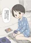  1girl :d bare_legs barefoot black_hair blue_pajamas blue_shirt blue_shorts blush brown_eyes buttons child collarbone collared_shirt commentary_request controller fang game_console game_controller gamecube gamecube_controller highres ichigo_mashimaro indoors itou_chika kirby_(series) long_sleeves looking_at_viewer nanoningen_(anapoko) on_pillow open_mouth pajamas pillow print_pajamas shirt short_hair short_shorts shorts sitting skin_fang smile solo translation_request wariza 
