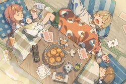  3girls absurdres annoyed ayumi blanket blonde_hair braid brown_hair card cellphone closed_eyes closed_mouth controller cup cushion food food_print fruit green_shorts green_tea hair_ornament highres kotatsu lying mandarin_orange multiple_girls on_back on_side onigiri_print open_mouth orange_peel original phone pink_hair playing_card pom_pom_(clothes) pom_pom_hair_ornament remote_control shorts sleeping smartphone socks table tea teapot twin_braids under_kotatsu under_table 