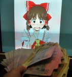  2d_dating blush bow brown_eyes brown_hair detached_sleeves hair_bow hakurei_reimu lonely money photo solo touhou 