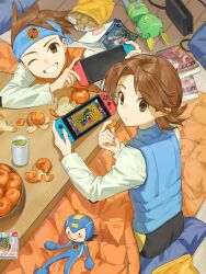  2boys black_shorts blue_headband blue_vest book brothers brown_eyes brown_hair doll headband highres hub_hikari_(mega_man) jinsu_exe kotatsu lan_hikari_(mega_man) looking_at_viewer male_focus medium_hair mega_man_(series) mega_man_battle_network_(series) mega_man_battle_network_3 mr._prog_(mega_man) multiple_boys nintendo_switch one_eye_closed orange_hair orange_vest shirt short_hair shorts siblings sitting table twins vest white_shirt wooden_floor 