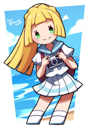  1girl backpack bag blonde_hair blue_sky camera commentary commission english_commentary green_eyes highres holding holding_camera lillie_(pokemon) looking_at_viewer ocean outdoors pokemon pokemon_sm shirt skirt sky solo umenodo white_shirt white_skirt 