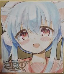  1girl :d absurdres animal_ears beret blue_hair blush hair_between_eyes hat highres kuriyuzu_kuryuu long_hair original photo_(medium) portrait red_eyes shikishi short_eyebrows signature smile solo thick_eyebrows traditional_media twintails white_hat 