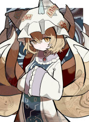  1girl absurdres animal_ear_headwear blonde_hair blue_tabard border breasts closed_mouth commentary cowboy_shot double-parted_bangs dress frilled_shirt_collar frilled_sleeves frills hair_between_eyes hands_in_opposite_sleeves hat highres kitsune long_sleeves looking_at_viewer medium_breasts mob_cap multiple_tails ofuda ofuda_on_clothes short_hair smile solo soresaki standing tabard tail touhou white_border white_dress white_hat wide_sleeves yakumo_ran yellow_eyes 