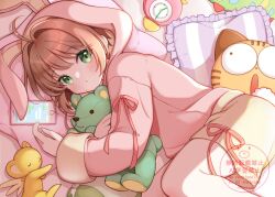  1girl :o animal_hood blush cardcaptor_sakura cellphone green_eyes highres hood hoodie kero_(cardcaptor_sakura) kinomoto_sakura long_sleeves medium_hair momo-tako open_mouth phone pillow pink_hoodie rabbit_hood shorts smartphone solo stuffed_animal stuffed_toy teddy_bear yellow_shorts 