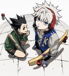  2boys arms_at_sides bent_back between_legs black_hair black_pants black_shorts blue_jacket blue_shoes brown_eyes child chupa_chups closed_mouth commentary_request eating elbow_on_thigh expressionless forehead from_above gon_freecss hand_between_own_legs hand_on_floor head_on_hand high_collar highres holding holding_skateboard hunter_x_hunter jacket killua_zoldyck looking_at_viewer ma0ma0_0 male_focus multiple_boys pants shoes short_hair shorts simple_background skateboard sleeves_past_wrists smile sneakers spiky_hair squatting standing tareme tile_floor tiles tsurime white_background 