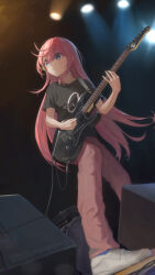  1girl absurdres black_shirt blue_eyes bocchi_the_rock! clothes_writing commentary cross-laced_shoes cube_hair_ornament dutch_angle english_commentary eyelashes eyes_visible_through_hair floating_hair from_below full_body gotoh_hitori guitar hair_between_eyes hair_ornament highres holding holding_guitar holding_instrument holding_plectrum indoors instrument long_hair looking_ahead one_side_up pants parted_lips pink_hair pink_pants playing_guitar playing_instrument plectrum shirt shoes short_sleeves sidelighting sidelocks smile sneakers solo spotlight stage standing straight_hair t-shirt tareme ti_hai_diao_yu very_long_hair white_shoes 