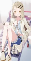  1girl absurdres belt blonde_hair blurry blurry_background blush brown_belt camisole closed_mouth collarbone colored_eyelashes commentary crocs denim denim_shorts depth_of_field earrings eimizzzzz expressionless fingernails flipped_hair full_body gakuen_idolmaster hair_ornament hairclip hand_on_own_chest hand_up highres idolmaster in_shopping_cart jewelry long_hair looking_at_viewer midriff_peek orange_eyes orange_ribbon parallel_hairclips parted_bangs ribbon robe rope_belt shinosawa_hiro shoes shopping_cart shorts sitting solo stud_earrings white_camisole white_robe white_shoes 