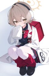  1girl backpack bag black_shirt blonde_hair blue_archive bow bowtie coat collared_shirt commentary_request covering_own_mouth earmuffs eyewear_hang glasses halo highres id_card leg_warmers loafers long_sleeves looking_at_viewer oversized_coat pantyhose rana_(blue_archive) randoseru red_bag red_bow red_bowtie red_leg_warmers rokukarashi shirt shoes short_hair simple_background sleeves_past_fingers sleeves_past_wrists solo squatting unworn_eyewear white_background white_coat white_pantyhose yellow_eyes yellow_halo 